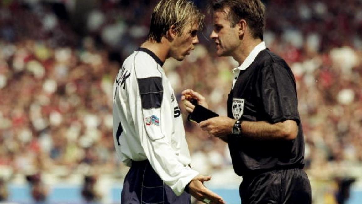 1 Aug 1999: David Beckham of Manchester United argues with referee Graham Barber and is booked during the FA Charity Shield match against Arsenal played at Wembley Stadium in London, England. The match finished in a 2-1 victory to the Arsenal. \ Mandatory Credit: Stu Forster /Allsport