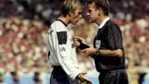 1 Aug 1999: David Beckham of Manchester United argues with referee Graham Barber and is booked during the FA Charity Shield match against Arsenal played at Wembley Stadium in London, England. The match finished in a 2-1 victory to the Arsenal. \ Mandatory Credit: Stu Forster /Allsport